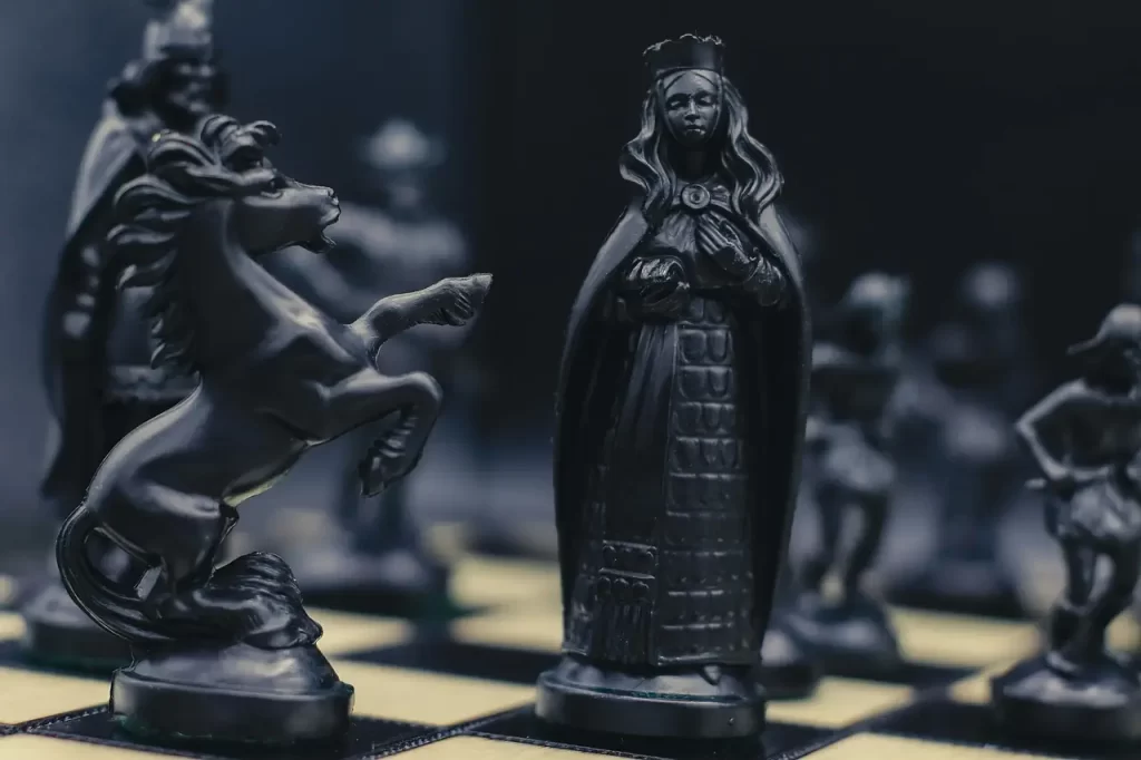 a chess queen standing proud on chess board