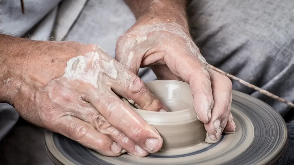 a man making a pot with his hands