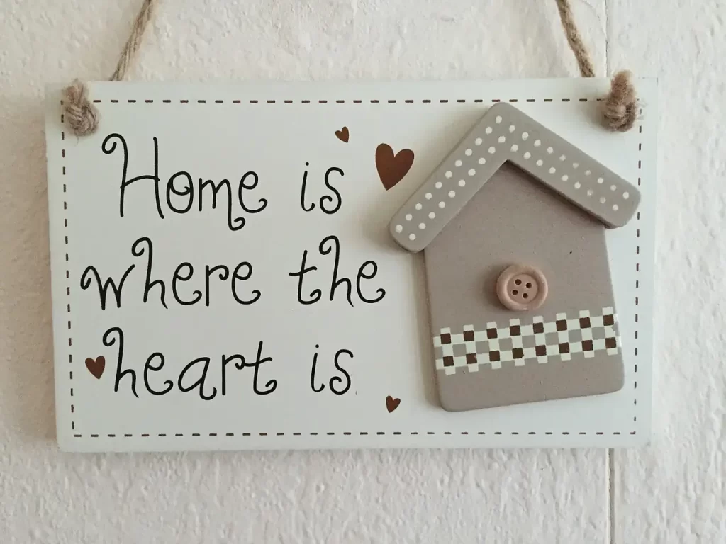 a sign that says home is where the heart is