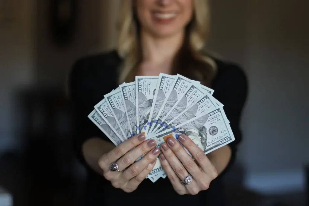 a woman holding a lot of money
