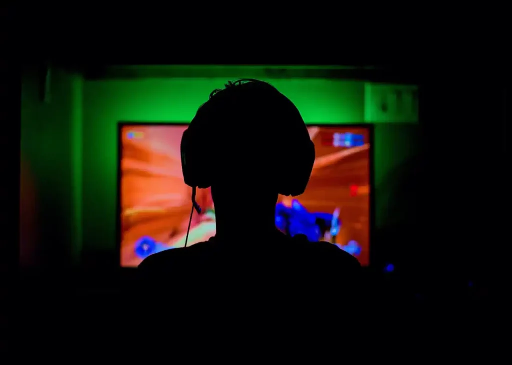 a gamer in a dark room playing games
